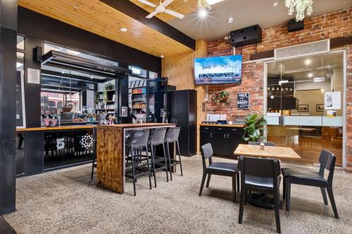 a bar in a restaurant with chairs and a counter at Quality Inn The George Hotel Ballarat in Ballarat
