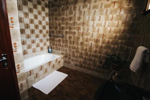 a bathroom with a bath tub and a sink at Casa da Avo Rosa in São Vicente