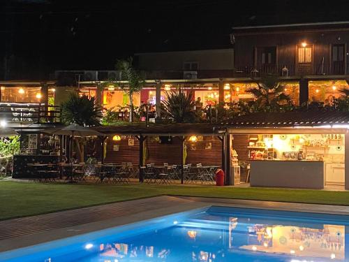 a resort with a swimming pool at night at Casa do Lago in Amarante