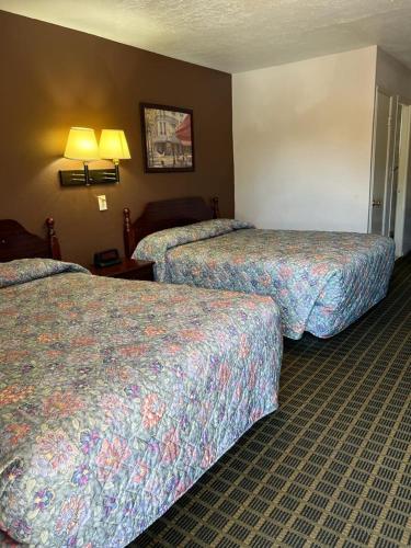a hotel room with two beds in a room at Aaron Motel in Portland