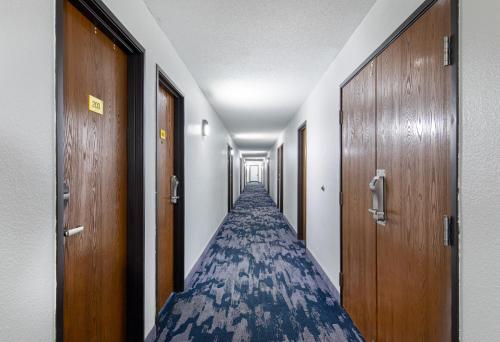 a corridor of a hospital hallway with wooden doors at Super 8 by Wyndham Johnson City in Johnson City