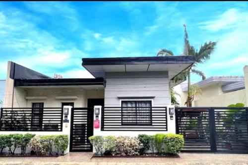 una casa con una cerca en blanco y negro en Home away from home., en Bacolod
