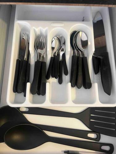 a drawer full of utensils in a refrigerator at Departamento centrico in Guadalajara
