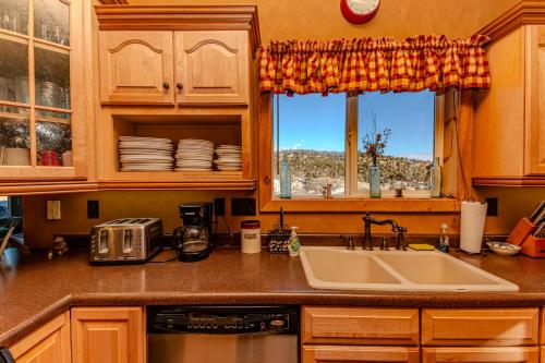 a kitchen with a sink and a window at The Honky Tonk Cabin in Long Valley Junction