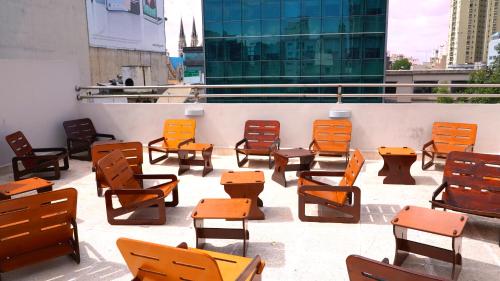 a group of chairs and tables on a balcony at Hotel Athos in Buenos Aires