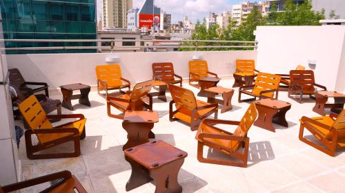 a group of chairs and tables on a roof at Hotel Athos in Buenos Aires