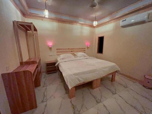 a bedroom with a large bed and a mirror at PrivHotel - Himandhoo in Himandhoo 