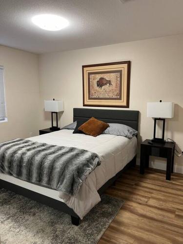 a bedroom with a large bed with two lamps at Mesquite Magic in Mesquite