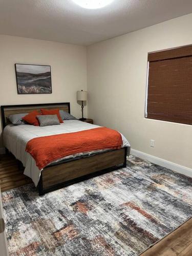 a bedroom with a bed and a rug at Mesquite Magic in Mesquite