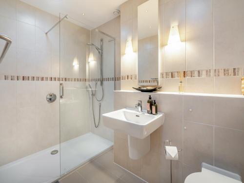 ein Bad mit einer Dusche, einem WC und einem Waschbecken in der Unterkunft Shore House in Kilcreggan