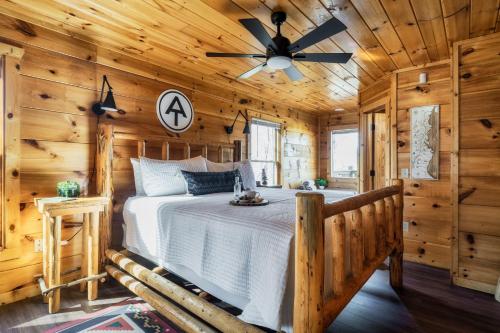 a bedroom with a bed in a log cabin at Updated Serene Mtn Cabin, theater rm & popcorn! in Sevierville