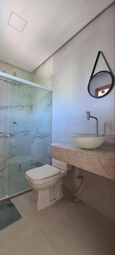 a bathroom with a toilet and a sink and a shower at White House - Taipú de Fora in Barra Grande