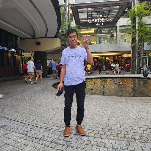 a man standing in front of a shopping center at Bayview hotel，pinang in Kuala Lumpur