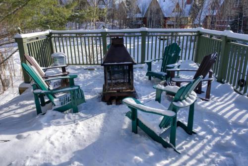 a group of chairs sitting in the snow at Le Plateau East by Tremblant Vacations in Mont-Tremblant