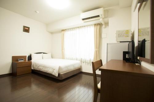 Säng eller sängar i ett rum på Hotel Hakata Place