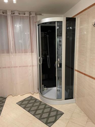 a bathroom with a shower with a mirror in it at A Casa Di Gigi in Latina