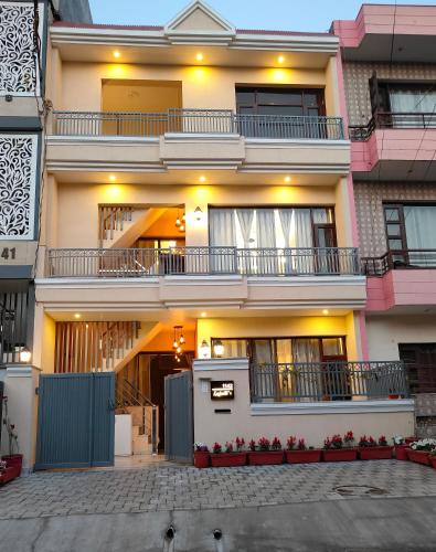 a large white building with balconies on it at Aura Home Stay in Mohali