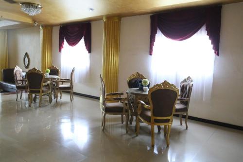 a dining room with a table and chairs at New Z Suites in Sunggal