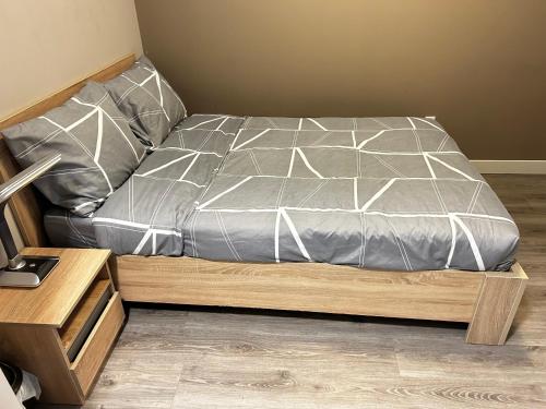 a bed sitting on a wooden platform in a bedroom at 1-bedroom condo near University of Waterloo in Waterloo