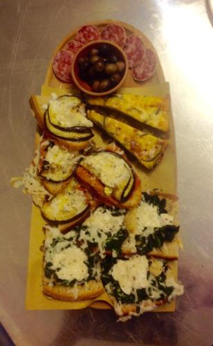 a plate of food with cheese and bread and olives at Il Sentiero in Acquapendente