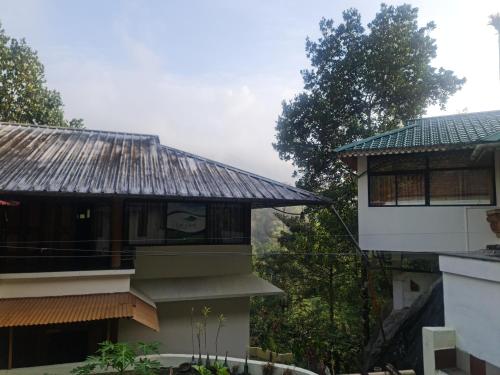 a building with a roof on top of it at River Rock Homestay in Anachal