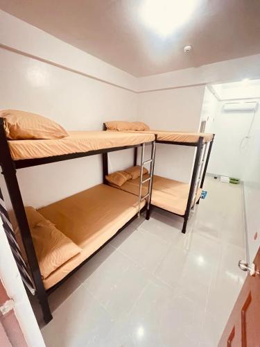 a room with two bunk beds in it at Villa Mariano Travellers Pad in Laoag