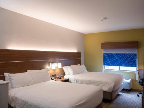 a hotel room with two beds and a window at Holiday Inn Express & Suites Greenville Airport i85 by IHG in Greer