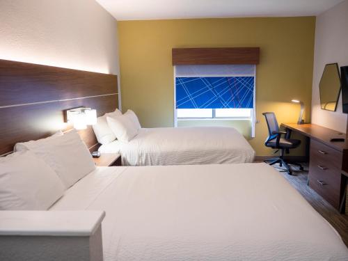 a hotel room with two beds and a window at Holiday Inn Express & Suites Greenville Airport i85 by IHG in Greer