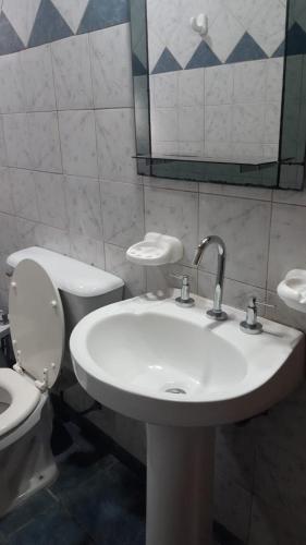 a bathroom with a sink and a toilet and a mirror at Ecos del Valle in San Rafael