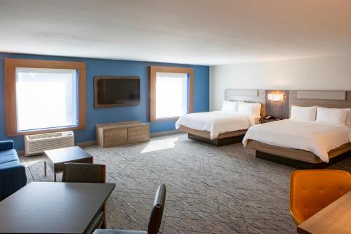 a hotel room with two beds and a flat screen tv at Holiday Inn Express & Suites Sioux City-South by IHG in Sioux City