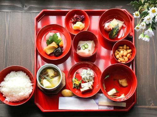 a red tray with bowls of food and rice at 京町家お宿・花 in Kyoto