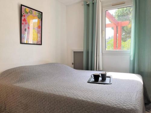 - une chambre avec un lit et une fenêtre avec une croix dans l'établissement Appartement en bord de mer avec terrasse, 3 pièces, 4 couchages, parking privé au Lavandou - FR-1-251-555, au Lavandou