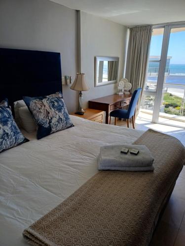 a bedroom with a bed with a view of the ocean at Cape Beach Penthouse in Cape Town