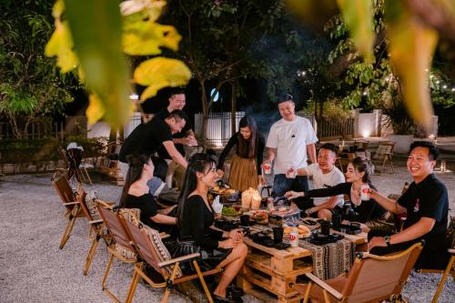 a group of people sitting around a table at Mai Chau Mountain View Resort in Mai Chau