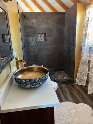 a bathroom with a bowl sink and a shower at The Lotus Yurt at Nomad Yurts, Lake Powell in Big Water