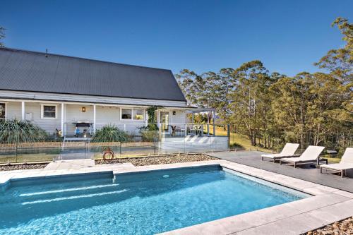 a house with a swimming pool in front of a house at Braeside, Kangaroo Valley in Kangaroo Valley