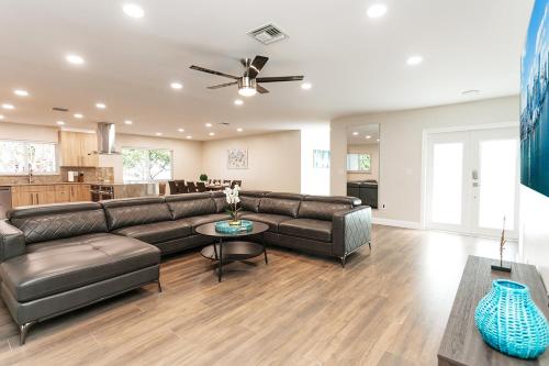 a living room with a couch and a table at Luxury 5BR Villa Heated Pool near Beach & Casino in Dania Beach