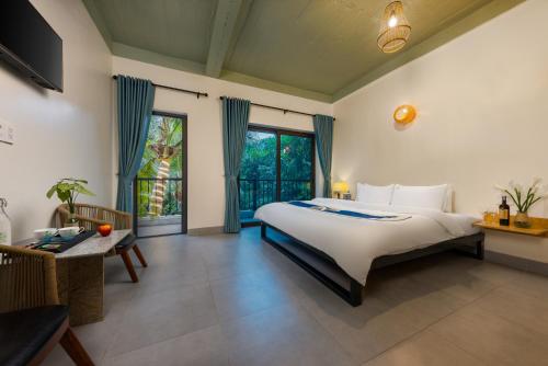 a bedroom with a bed and a large window at Tropical retreat Homestay in Cat Ba