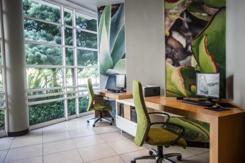 an office with a desk and two chairs and a window at Garden Court Sandton City in Johannesburg