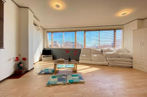 a living room with a couch and a table at Mitomi Home 4F in Tokyo