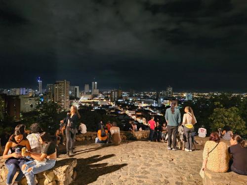 a group of people sitting on top of a rock ledge at Casa Alba in Cali