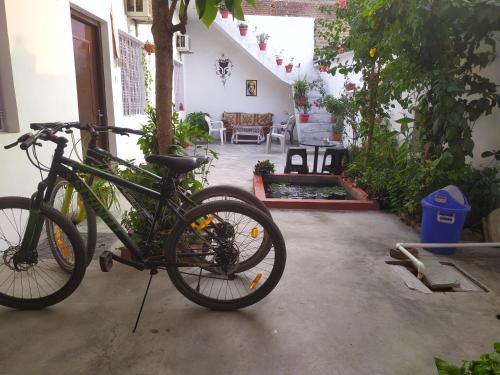 a bike is parked in a garage at The Highvill Home Stay in Khajurāho