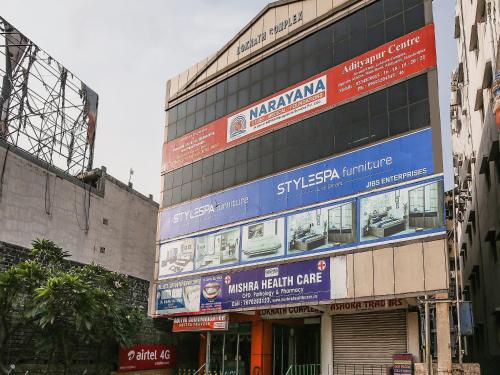 een hoog gebouw met borden aan de zijkant bij OYO Flagship Hotel Lokenath in Jamshedpur