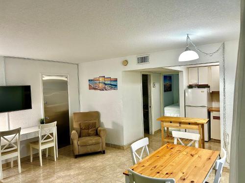 a kitchen and living room with a table and a dining room at Horizon by the Sea Inn in Fort Lauderdale