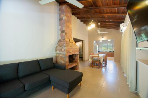 a living room with a couch and a fireplace at Vista Alegre Natural Resort - Villas & Cabañas in Independencia