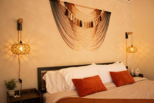 a bedroom with a bed with orange and white pillows at Avani in Contadora