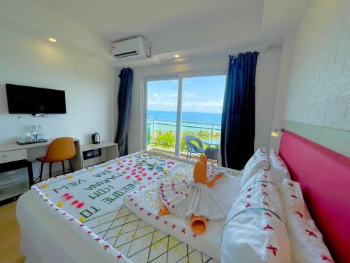 a bedroom with a bed with a view of the ocean at iCom Marina Sea View in Maafushi