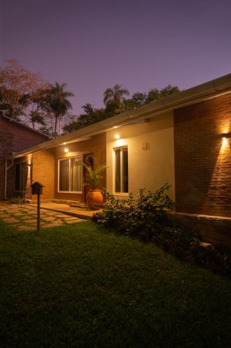 a house with lights on the side of it at night at Vista Alegre Natural Resort - Villas & Cabañas in Independencia