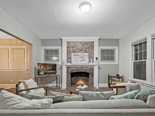 a living room with a fireplace and a couch at Chic 2BR Duplex Free Parking near Hospitals in Des Moines
