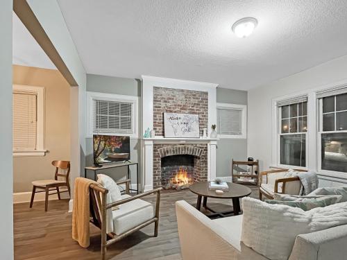 a living room with a fireplace and a couch at Chic 2BR Duplex Free Parking near Hospitals in Des Moines
